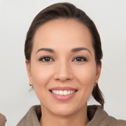 Joyful white young-adult female with medium  brown hair and brown eyes