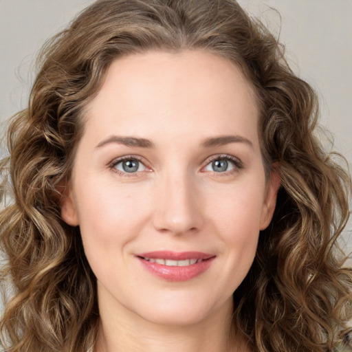 Joyful white young-adult female with long  brown hair and green eyes