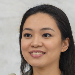 Joyful asian young-adult female with long  black hair and brown eyes