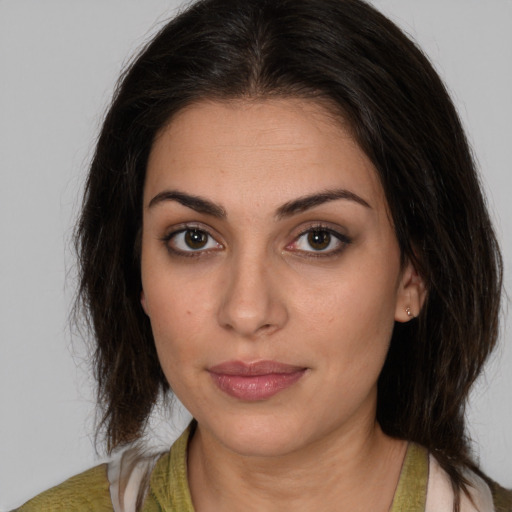 Joyful white young-adult female with medium  brown hair and brown eyes