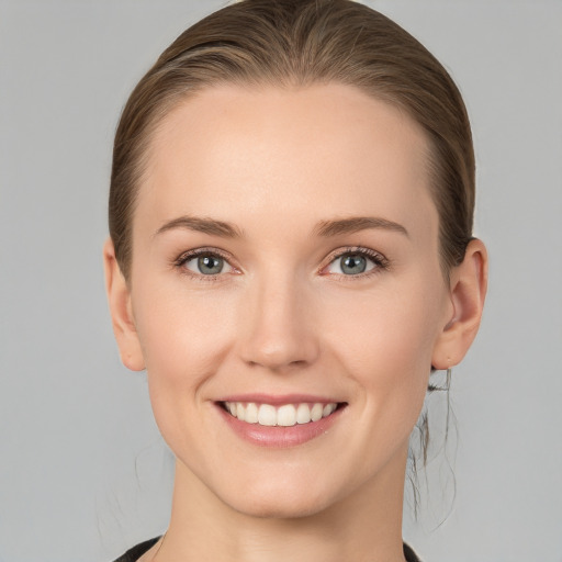 Joyful white young-adult female with medium  brown hair and blue eyes