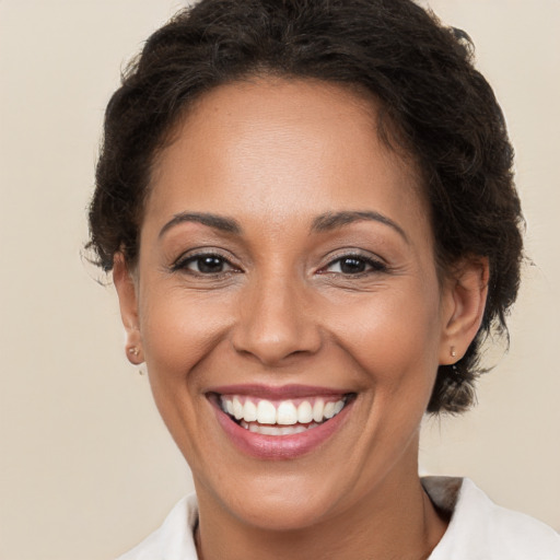 Joyful white adult female with short  brown hair and brown eyes