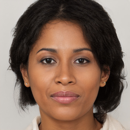 Joyful black young-adult female with medium  brown hair and brown eyes