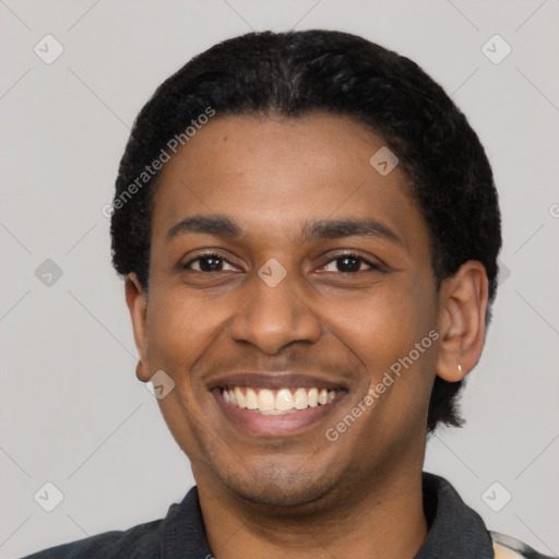 Joyful latino young-adult male with short  black hair and brown eyes