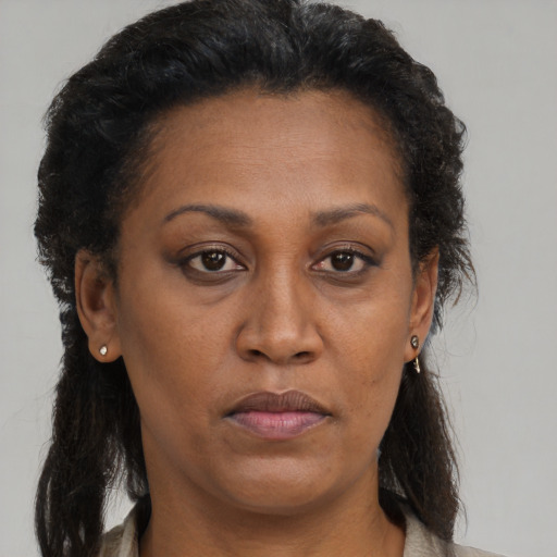 Neutral black adult female with long  brown hair and brown eyes