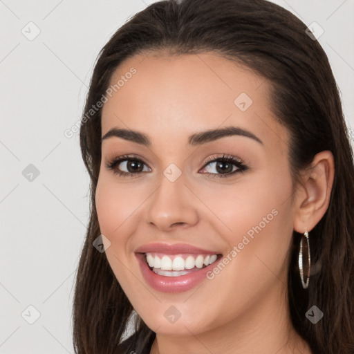 Joyful white young-adult female with long  brown hair and brown eyes