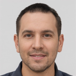 Joyful white young-adult male with short  brown hair and brown eyes