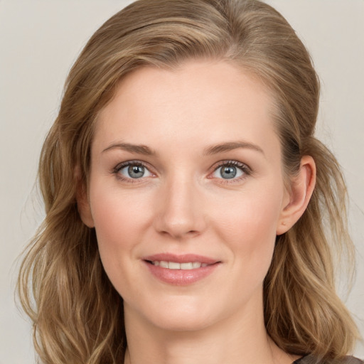 Joyful white young-adult female with long  brown hair and grey eyes