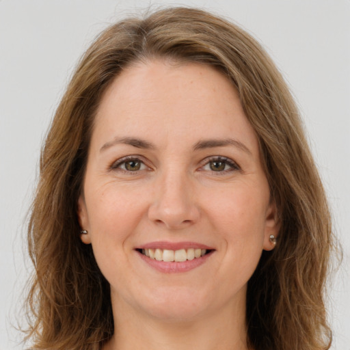 Joyful white young-adult female with long  brown hair and green eyes