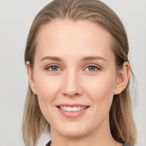 Joyful white young-adult female with medium  brown hair and grey eyes