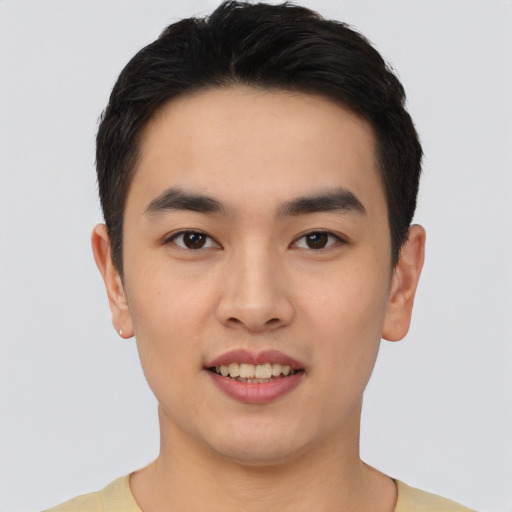 Joyful asian young-adult male with short  black hair and brown eyes