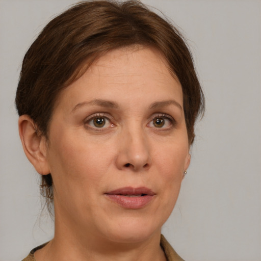 Joyful white adult female with medium  brown hair and grey eyes