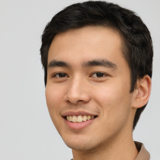 Joyful asian young-adult male with short  black hair and brown eyes