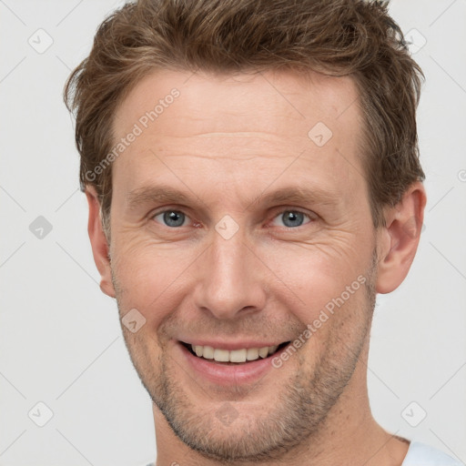 Joyful white adult male with short  brown hair and grey eyes