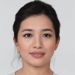 Joyful asian young-adult female with medium  brown hair and brown eyes