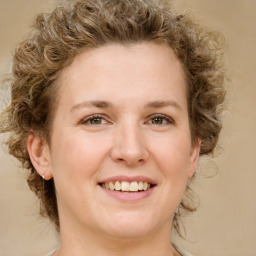 Joyful white young-adult female with medium  brown hair and green eyes