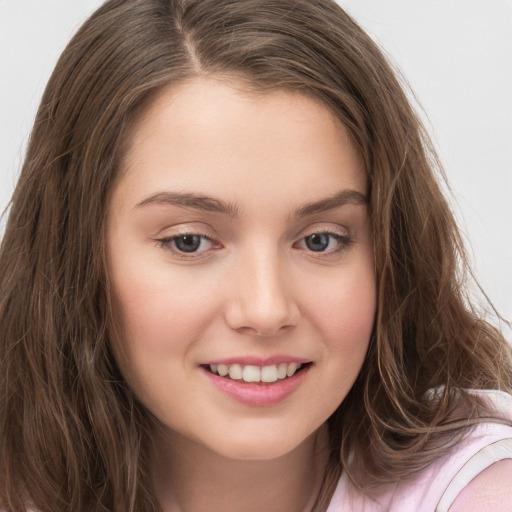 Joyful white child female with long  brown hair and brown eyes