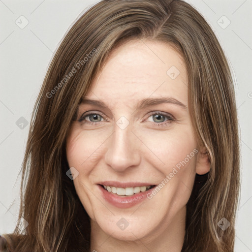 Joyful white adult female with long  brown hair and grey eyes