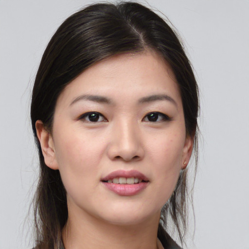 Joyful asian young-adult female with medium  brown hair and brown eyes