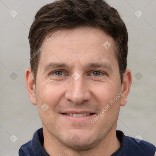 Joyful white adult male with short  brown hair and grey eyes