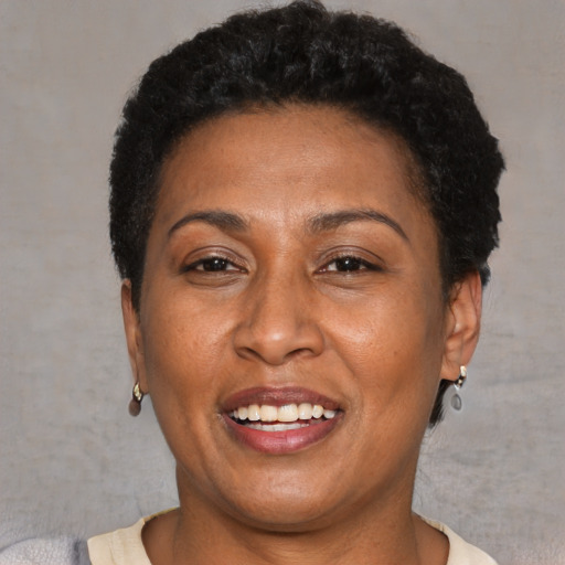 Joyful latino adult female with short  brown hair and brown eyes