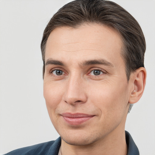 Joyful white adult male with short  brown hair and brown eyes