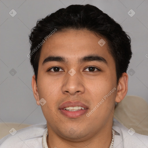 Joyful latino young-adult male with short  brown hair and brown eyes