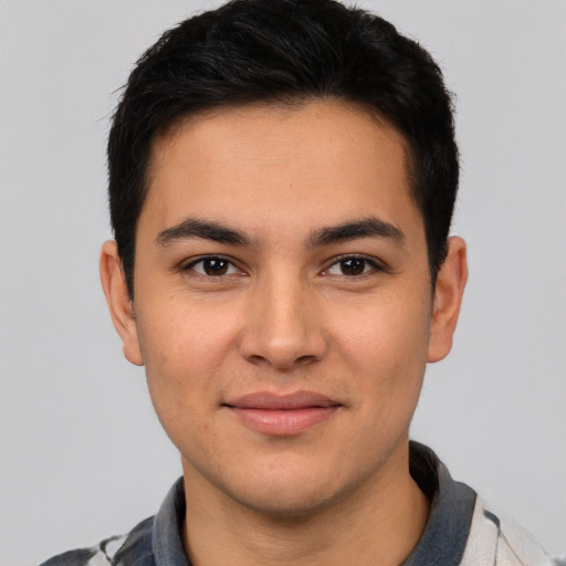 Joyful latino young-adult male with short  brown hair and brown eyes