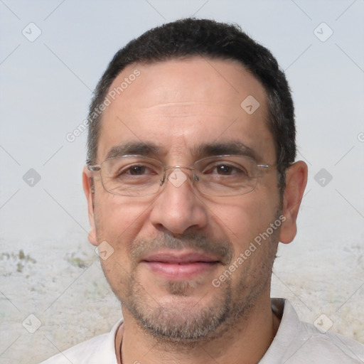 Joyful white adult male with short  black hair and brown eyes