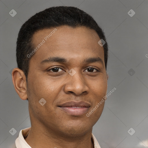Joyful latino young-adult male with short  brown hair and brown eyes