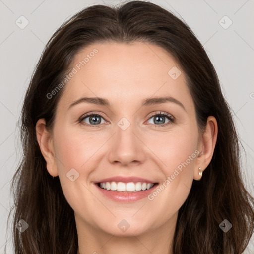 Joyful white young-adult female with long  brown hair and grey eyes