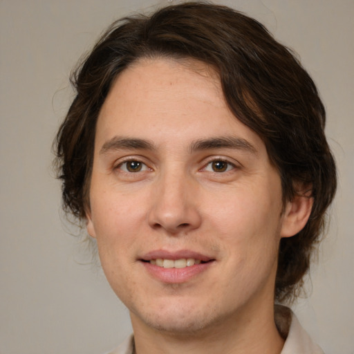 Joyful white young-adult male with medium  brown hair and brown eyes