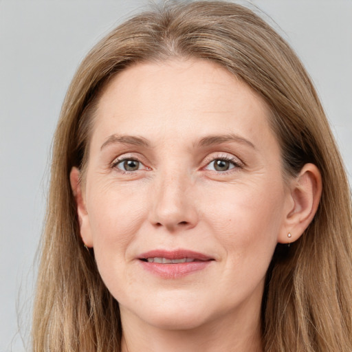 Joyful white adult female with long  brown hair and grey eyes