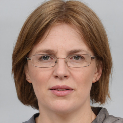 Joyful white adult female with medium  brown hair and blue eyes