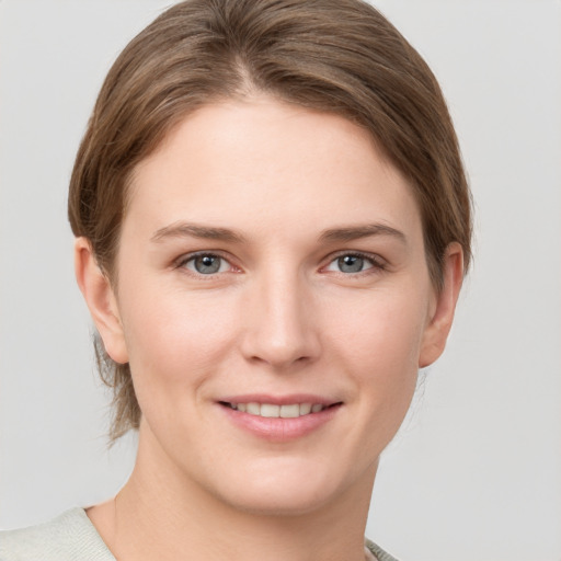 Joyful white young-adult female with short  brown hair and grey eyes