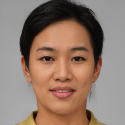 Joyful asian young-adult female with short  brown hair and brown eyes