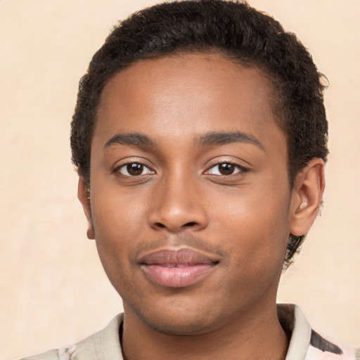 Joyful black young-adult male with short  brown hair and brown eyes