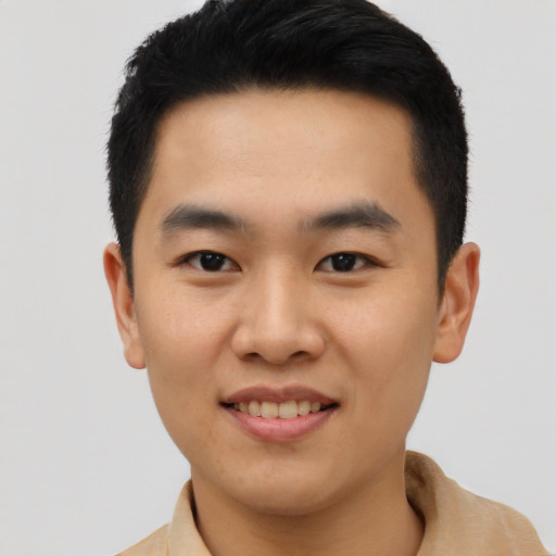 Joyful asian young-adult male with short  black hair and brown eyes
