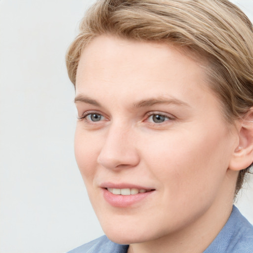 Joyful white young-adult female with short  brown hair and blue eyes