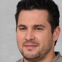 Joyful white adult male with short  brown hair and brown eyes