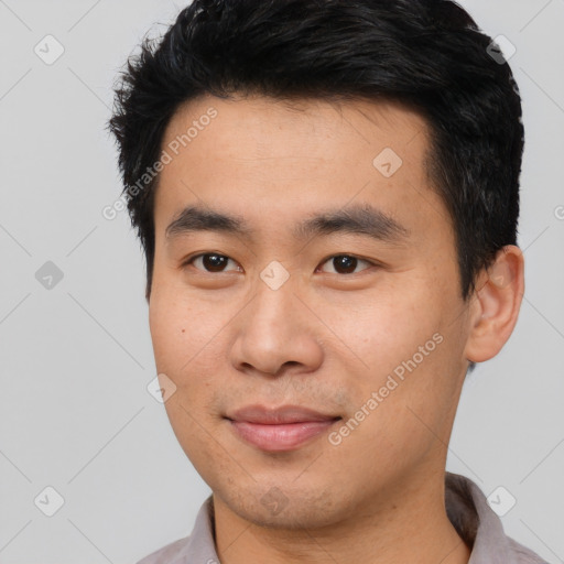 Joyful asian young-adult male with short  black hair and brown eyes