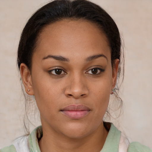 Joyful latino young-adult female with medium  brown hair and brown eyes