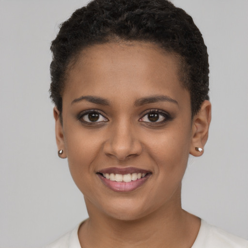 Joyful black young-adult female with short  brown hair and brown eyes