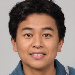 Joyful asian young-adult male with short  brown hair and brown eyes