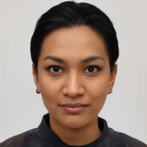 Joyful latino young-adult female with short  black hair and brown eyes