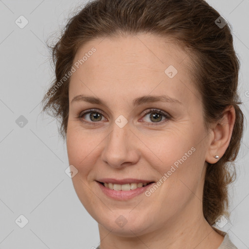 Joyful white adult female with medium  brown hair and brown eyes