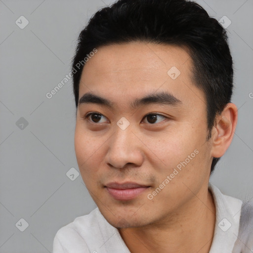 Joyful latino young-adult male with short  black hair and brown eyes