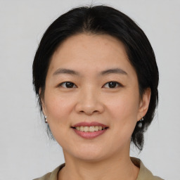 Joyful asian young-adult female with medium  black hair and brown eyes