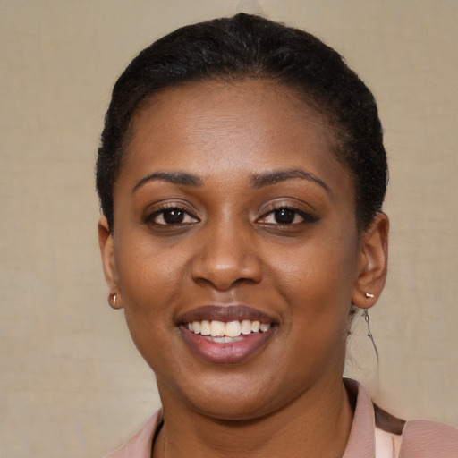 Joyful black young-adult female with short  brown hair and brown eyes