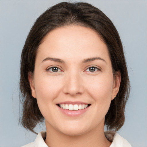 Joyful white young-adult female with medium  brown hair and brown eyes